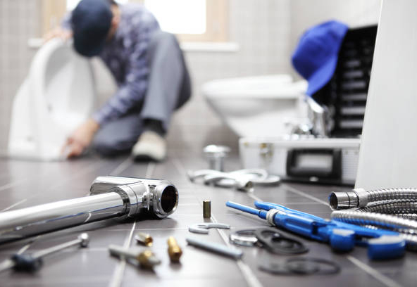 plumber at work in a bathroom, plumbing repair service, assemble and install concept